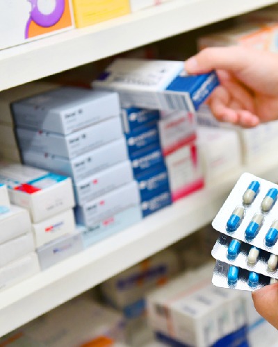 Pharmacist selecting medicine on the medicine shelf