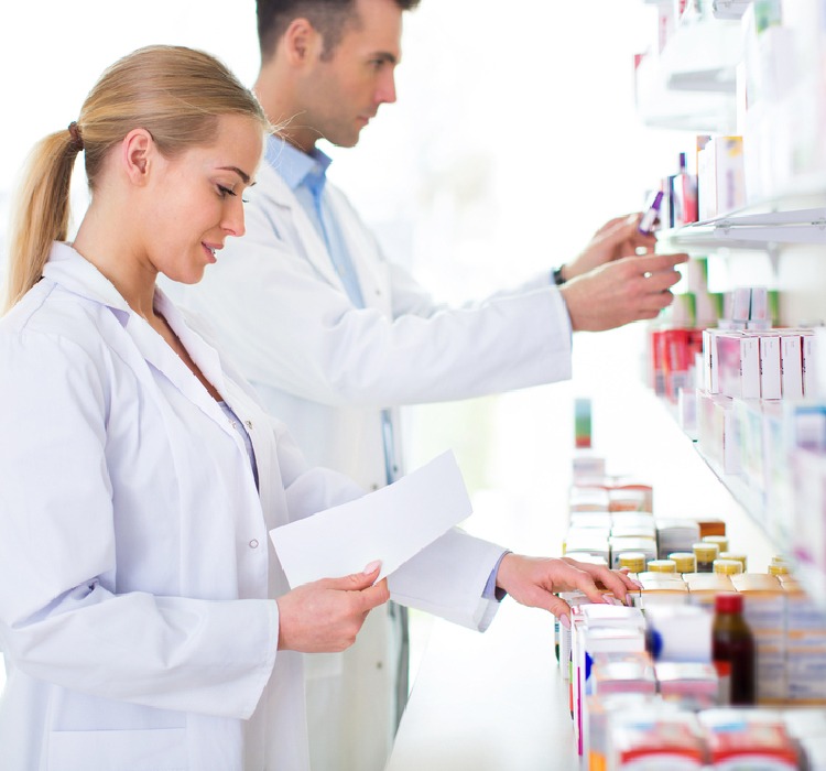 Pharmacist selecting medicine on the medicine shelf